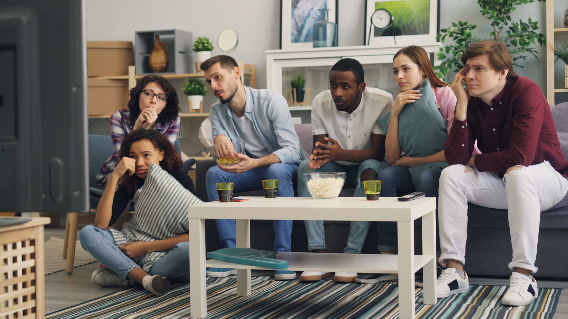 Focus group people watching modern studio TV screen